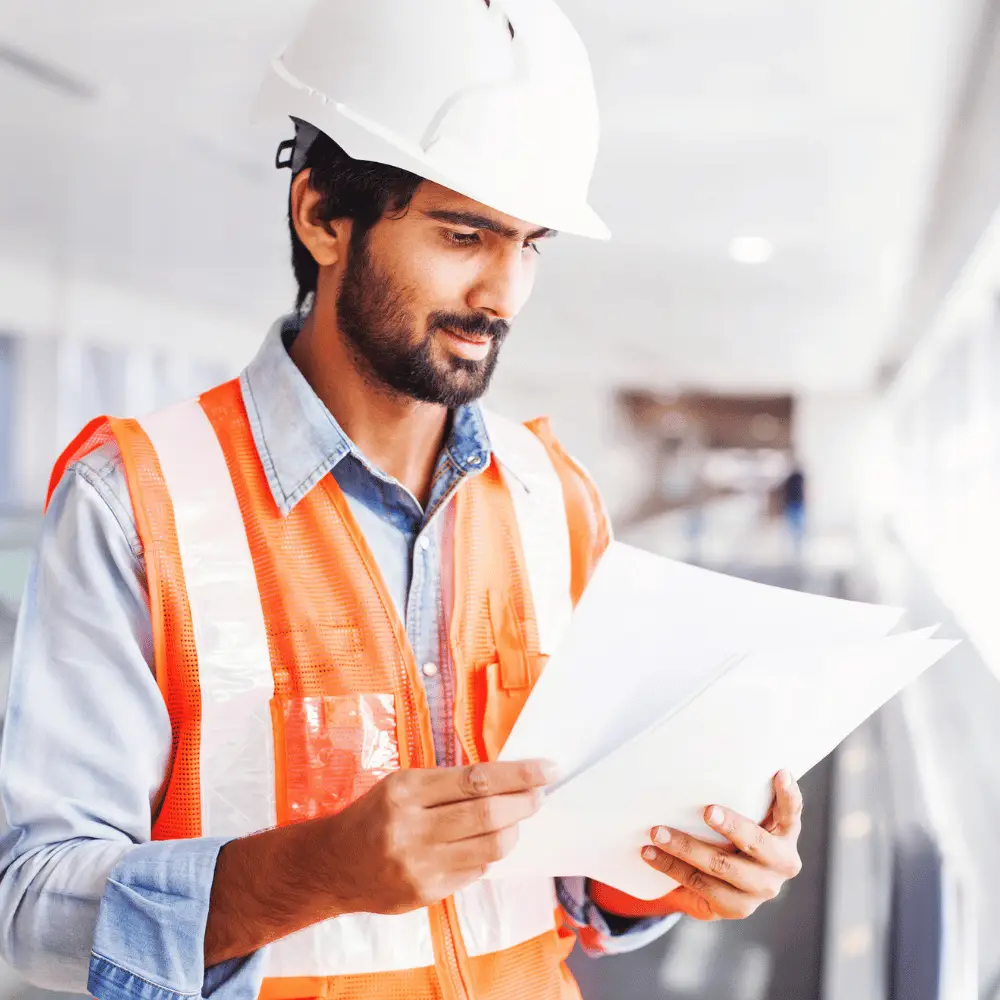 Construction man looking at paperwork